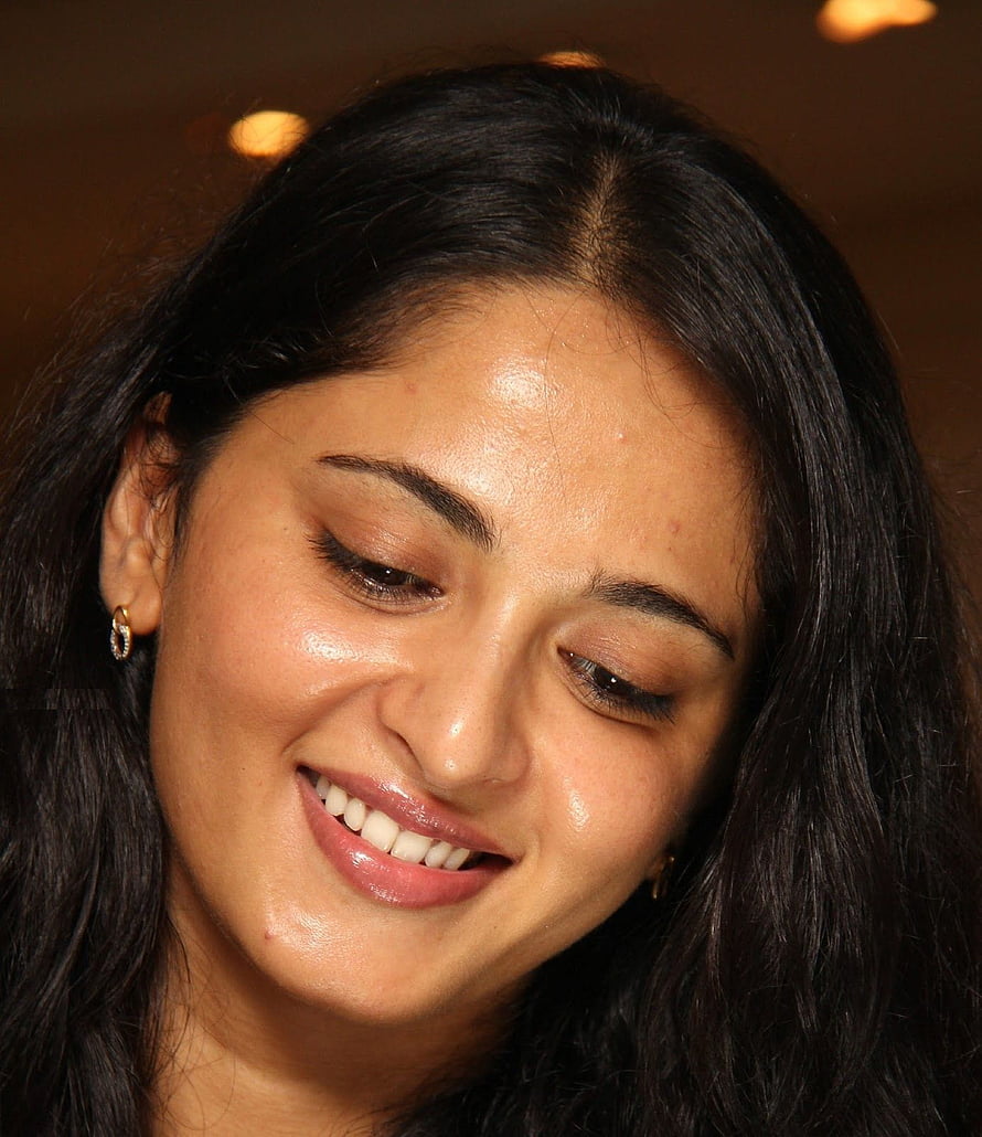 Anushka Shetty Close-Up Portrait with Warm Smile and Dark Hair HD phone wallpaper