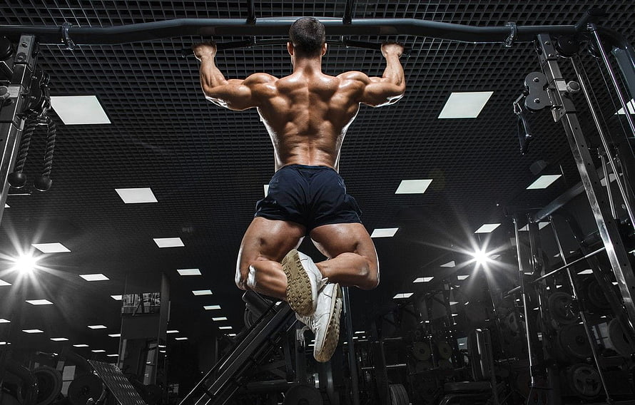 Muscular Male Athlete Performing Pull-Up on Gym Horizontal Bar HD wallpaper