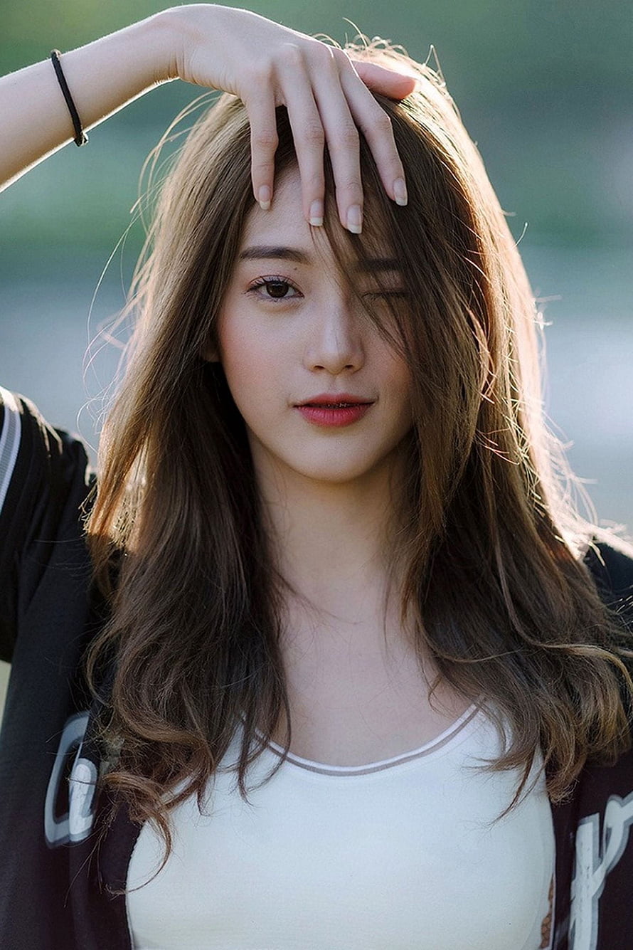 Portrait of a young woman with long brown hair winking and shielding her eyes from the sun, Young Girl posted by Samantha Simpson, stylish chinese cute girl HD phone wallpaper