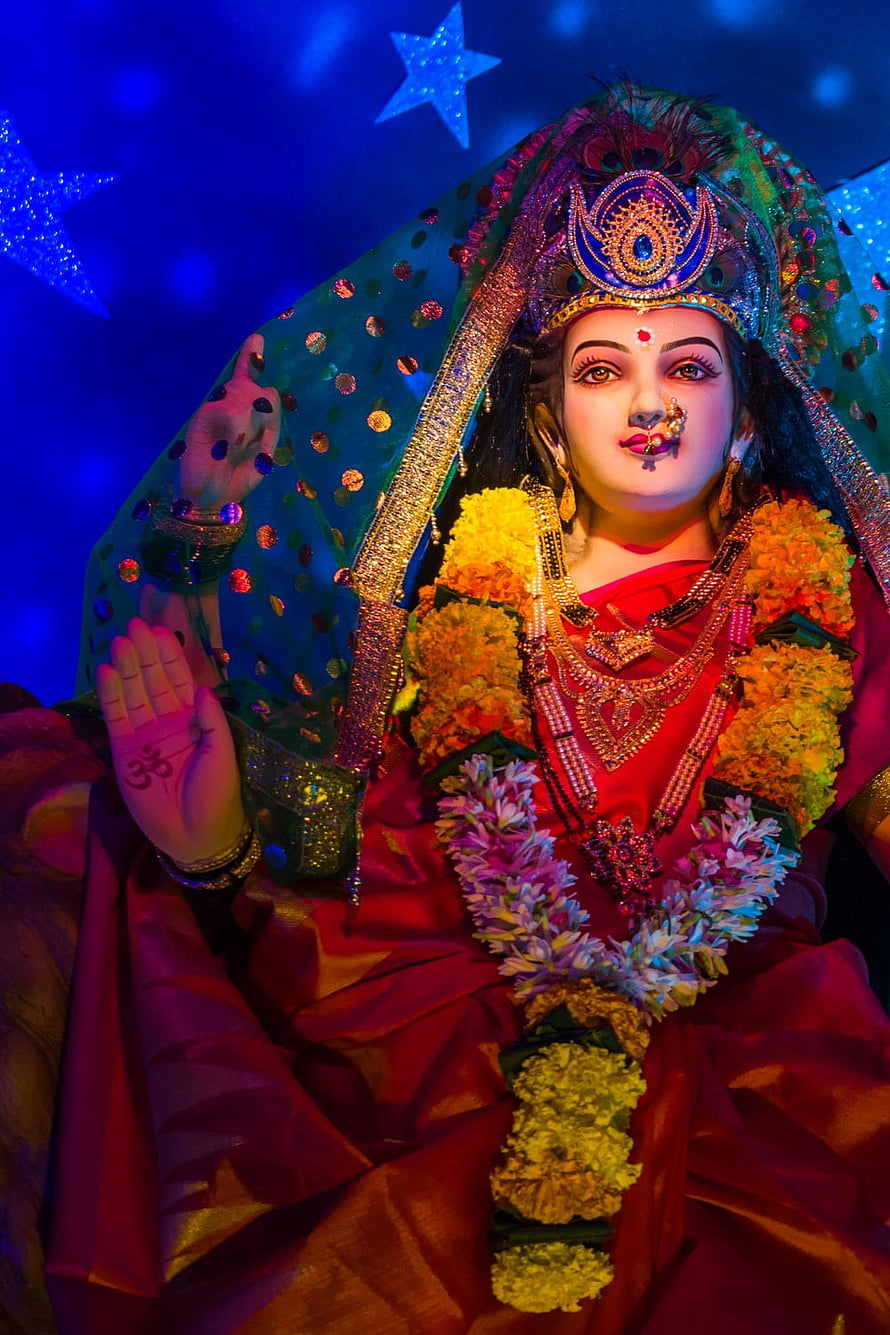 Ornate Navratri Mata Idol Adorned With Floral Garlands And Traditional Jewelry HD phone wallpaper