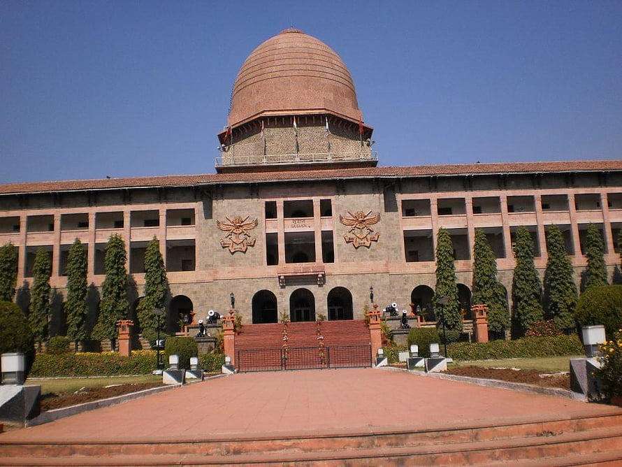Rashtrapati Bhavan in New Delhi, India, showcasing its grand dome, red sandstone architecture, and symmetrical gardens under a clear blue sky HD wallpaper