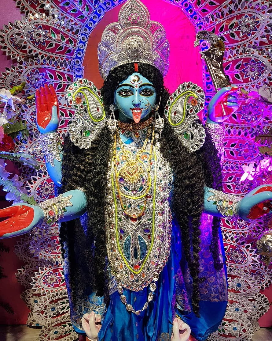 Maa Kali Thakur with ornate silver crown and elaborate jewelry against vibrant pink mandala backdrop HD phone wallpaper