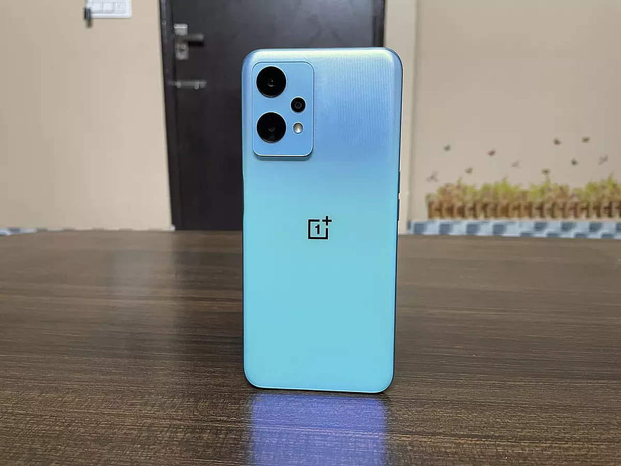 OnePlus Nord CE 2 Lite 5G in Light Blue Standing on a Wooden Table HD wallpaper