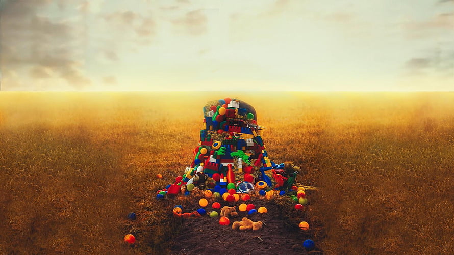 Colorful Toy Pile in Golden Field at Sunset HD wallpaper