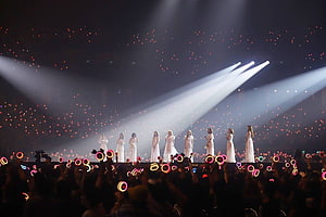 TWICE Concert Stage Performance in White Dresses with Glowing Light Sticks HD wallpaper