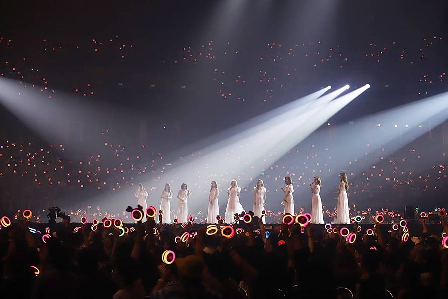 TWICE Concert Stage Performance in White Dresses with Glowing Light Sticks HD wallpaper