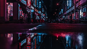 Neon-lit Asian street at night with vivid reflections in a rain puddle HD wallpaper