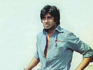 Amitabh Bachchan in a distressed blue shirt with a serious expression HD wallpaper
