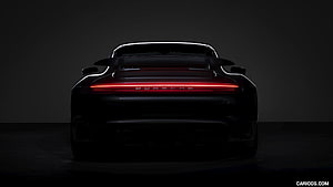 Porsche 911 Turbo S Rear View with Glowing Light Bar in Dark Studio Setting HD wallpaper