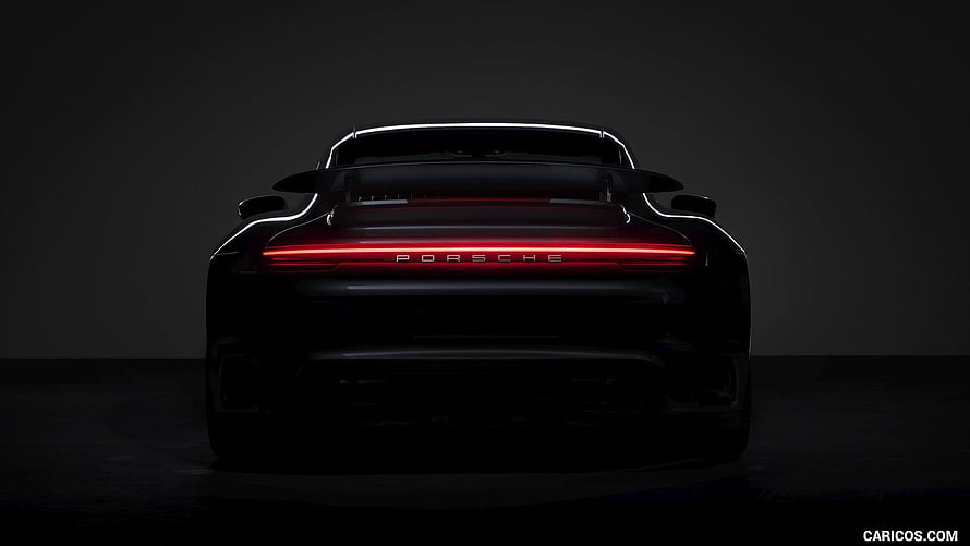 Porsche 911 Turbo S Rear View with Glowing Light Bar in Dark Studio Setting HD wallpaper