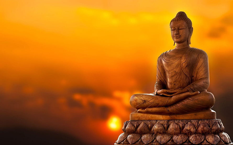 Gautam Buddha statue in meditation pose against a warm golden sunset sky HD wallpaper