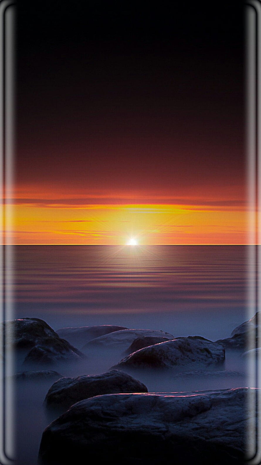Serene Sunset Over Calm Ocean With Silhouetted Rocks And Vibrant Sky Gradient HD phone wallpaper
