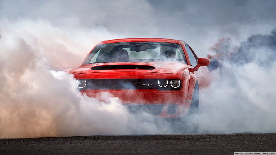 Red Dodge Challenger SRT Hellcat performing a dramatic burnout in thick smoke HD wallpaper