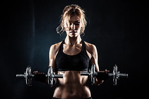 Athletic Woman Performing Bicep Curls With Dumbbells In Dark Studio Setting, Fitness Gym Girl, Others, gym body HD wallpaper