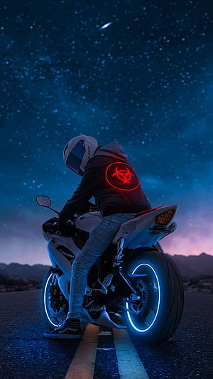 Biker with glowing red biohazard hoodie on neon motorcycle under starry night sky HD phone wallpaper