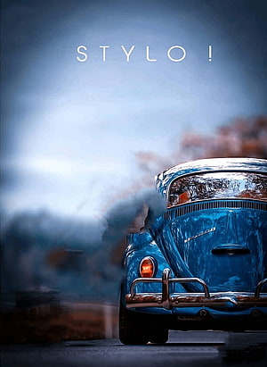 Rear View of a Classic Blue Volkswagen Beetle with Exhaust Smoke on a Misty Road HD phone wallpaper