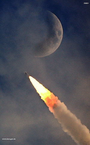ISRO Chandrayaan 1 rocket launch with bright flame trail against a large moon in the night sky HD phone wallpaper