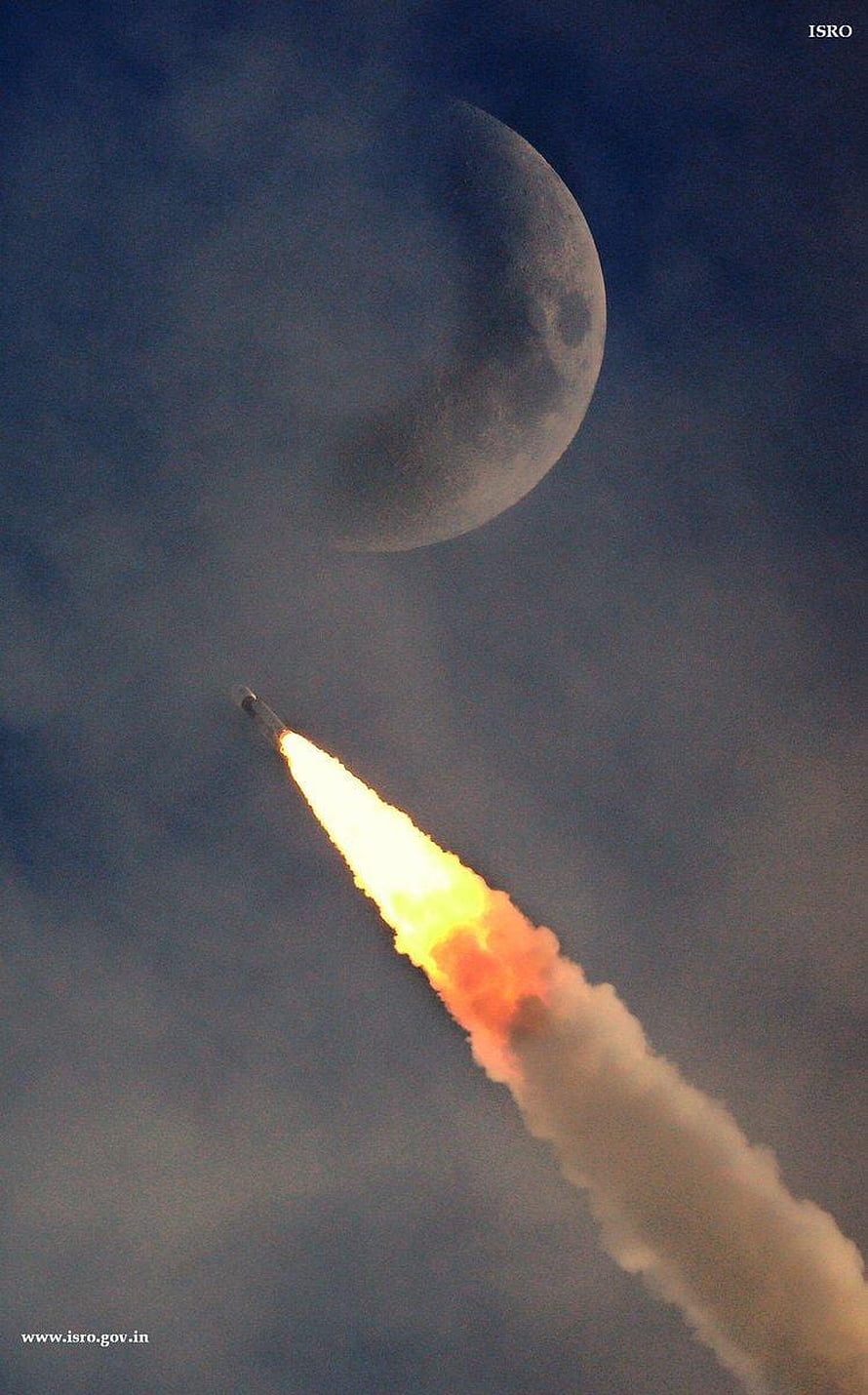 ISRO Chandrayaan 1 rocket launch with bright flame trail against a large moon in the night sky HD phone wallpaper