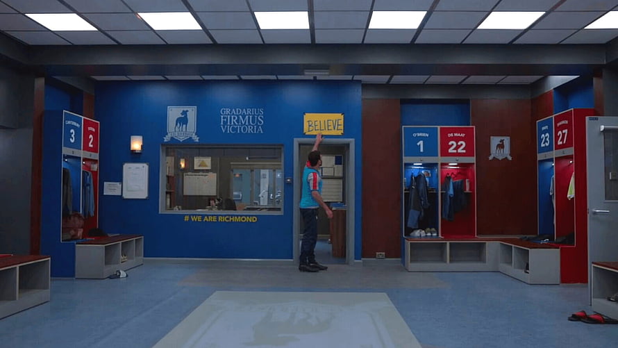 Ted Lasso Richmond FC Locker Room Scene with Believe Sign and Player HD wallpaper