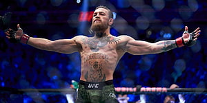 Conor McGregor Celebrating Victory in the UFC Octagon with Arms Raised HD wallpaper