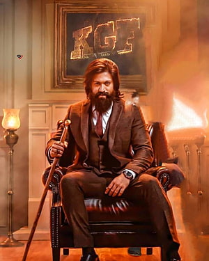 KGF Rocky Character in Brown Suit Seated in Leather Chair with Cane and Fire HD phone wallpaper