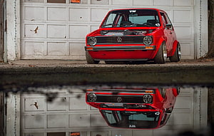 Red VW Golf MK1 Stance Build Parked in Front of Garage Door with Water Reflection HD wallpaper