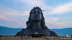 Adiyogi Statue at Isha Foundation with Serene Sky and Mountain Backdrop HD wallpaper
