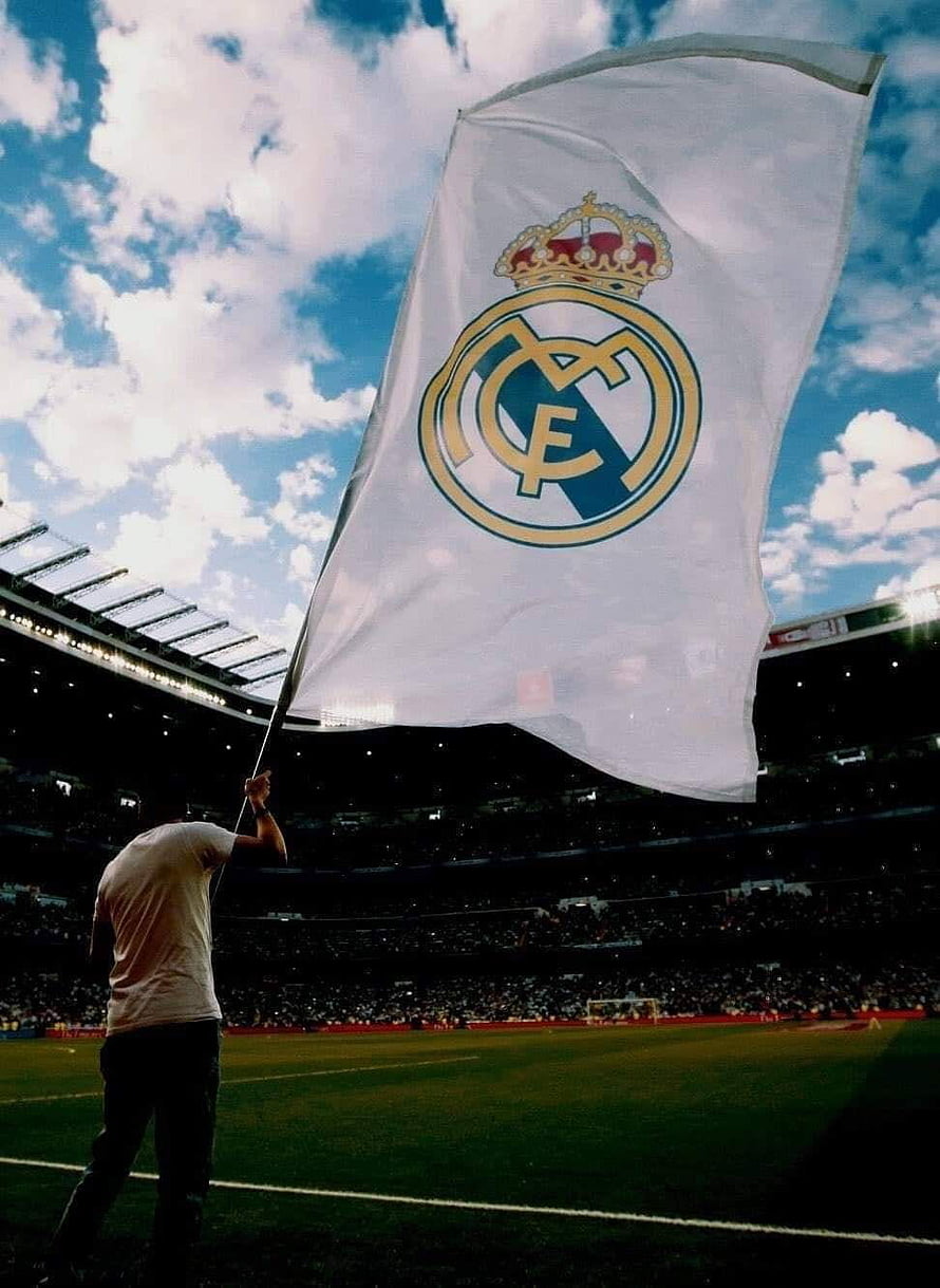 Real Madrid Club Crest Flag Waving Over Stadium Pitch Under Blue Sky HD phone wallpaper