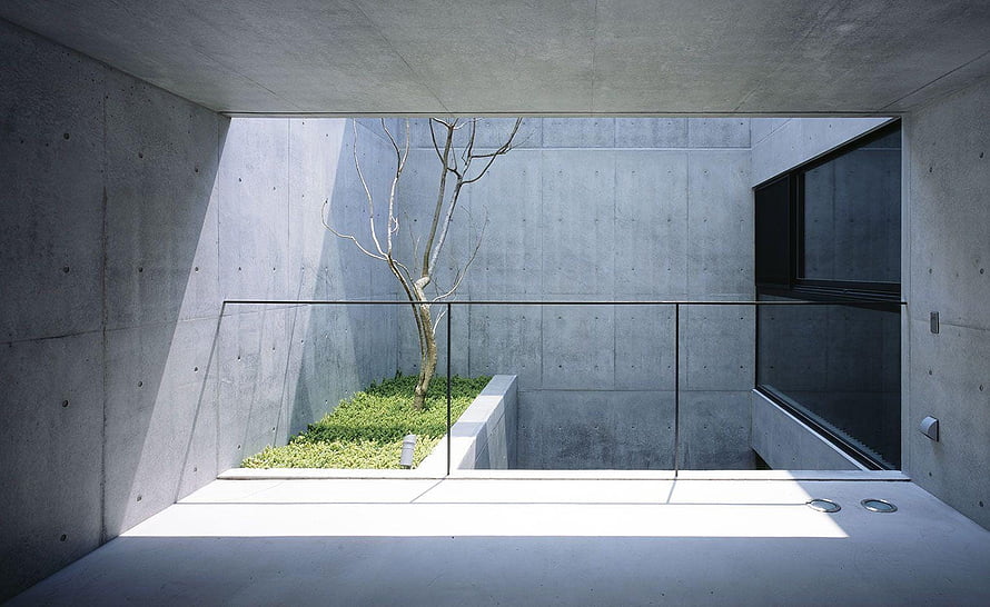 Minimalist Concrete Courtyard with Bare Tree and Glass Railing HD wallpaper