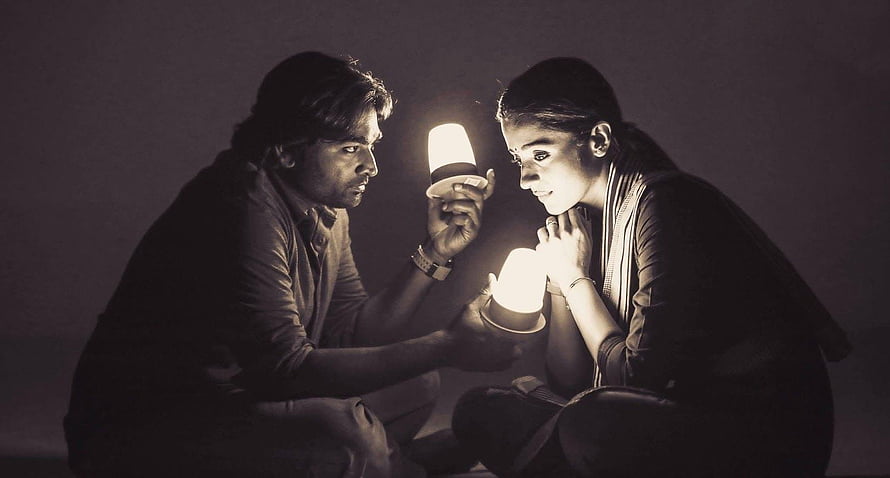 Couple Examining Solar Lamps in Dim Lighting HD wallpaper