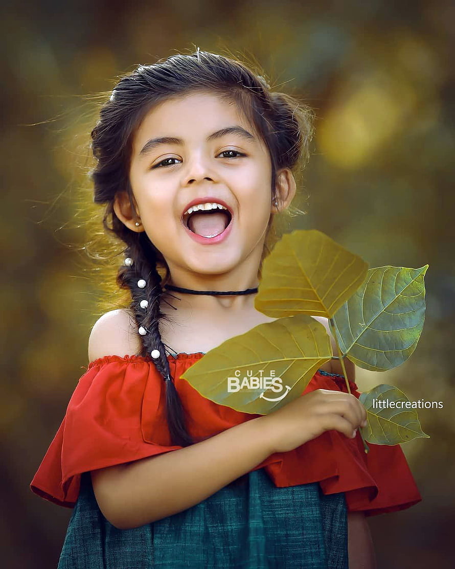 Smiling Indian Girl in Red Off-Shoulder Dress Holding Green Leaves HD phone wallpaper