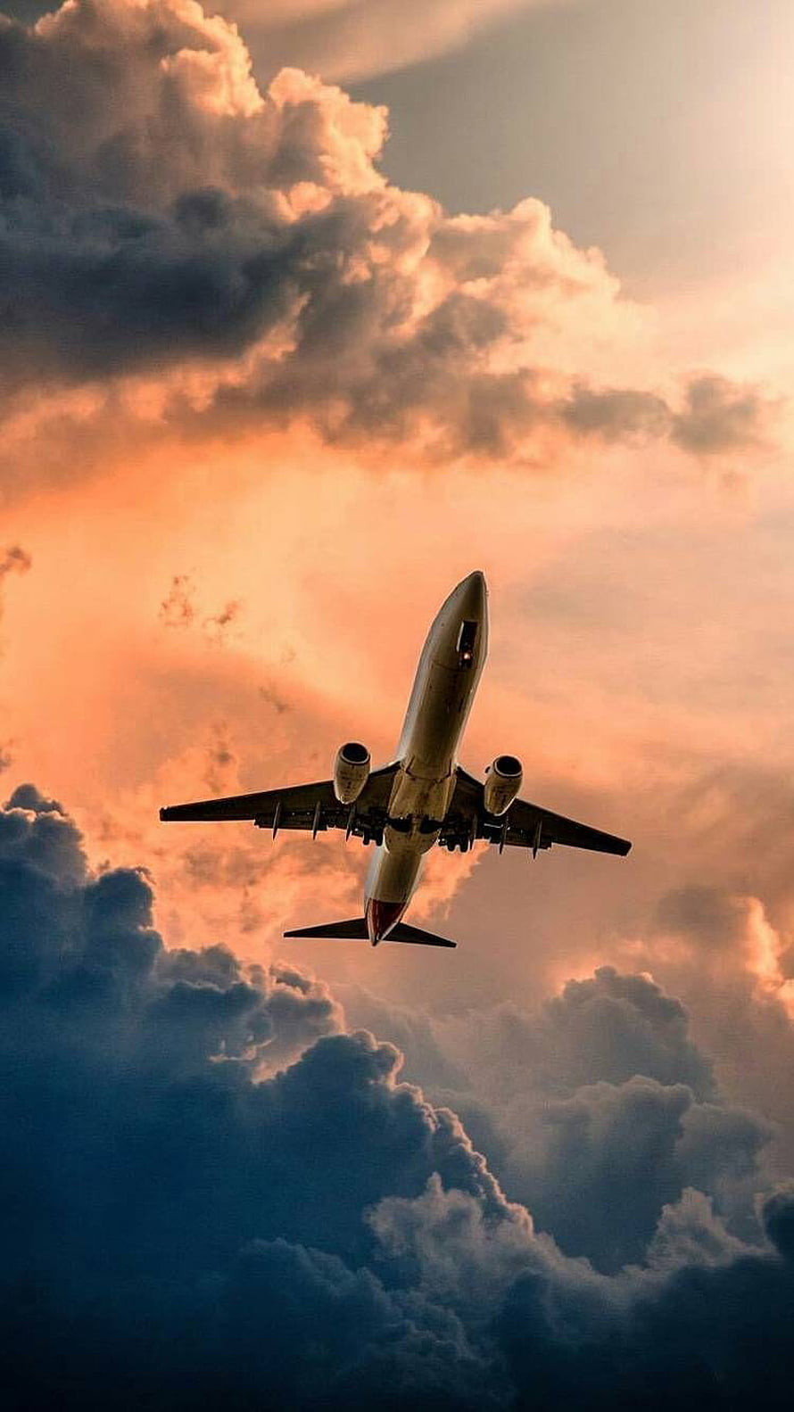 Commercial Airplane Flying Through Dramatic Sunset Clouds HD phone wallpaper