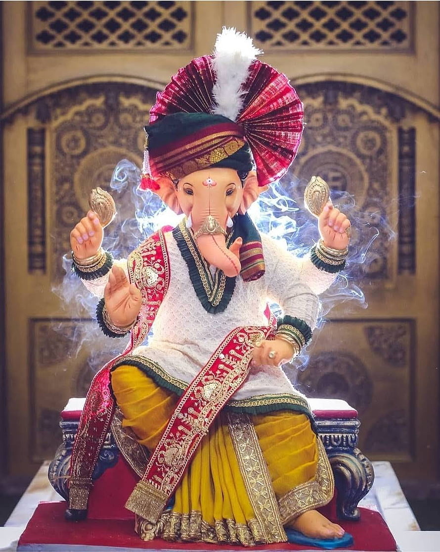 Lord Ganesha Idol in Traditional Rajasthani Attire with Turban and Gold Coins HD phone wallpaper