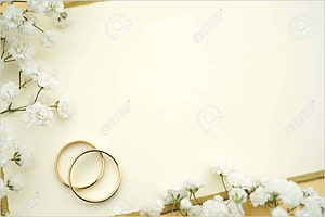 Elegant gold wedding rings with white flowers on a soft cream background HD wallpaper