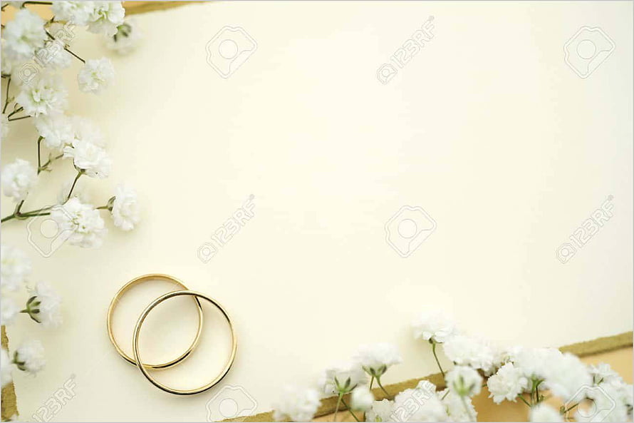 Elegant gold wedding rings with white flowers on a soft cream background HD wallpaper