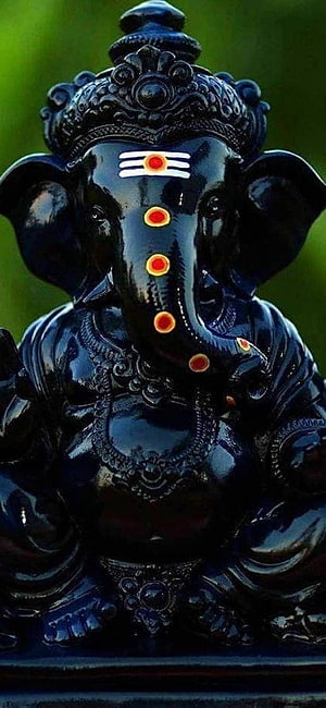 Black Ganpati Murti with Red Tilak and Ornate Crown HD phone wallpaper