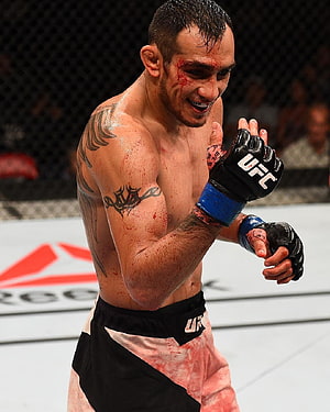 Tony Ferguson in the UFC Octagon Wearing Black Gloves and Blood-Stained Shorts HD phone wallpaper
