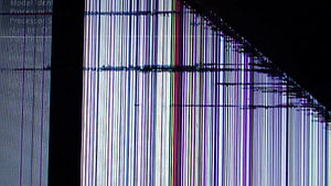 Close-up of a damaged LCD monitor displaying vertical color lines and digital glitch artifacts HD wallpaper