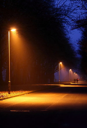 Atmospheric Night Street Scene With Glowing Orange Streetlights And Foggy Blue Sky HD phone wallpaper