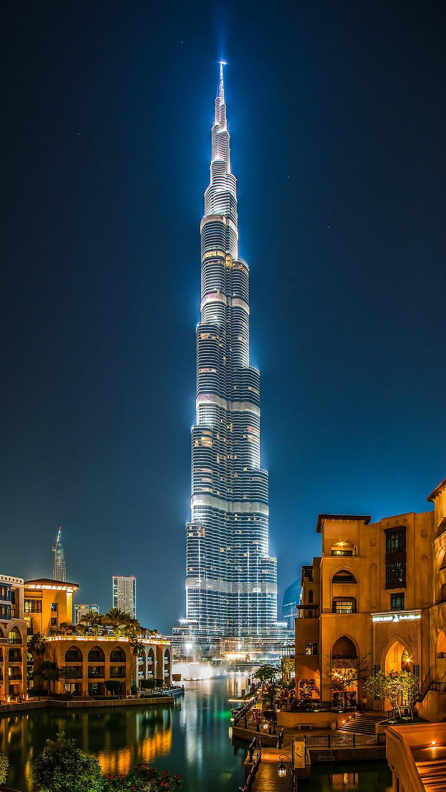 Burj Khalifa Illuminated at Night Over Dubai Canal with Warm Architectural Reflections HD phone wallpaper