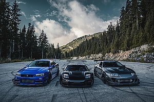 Three JDM Legends: Nissan R34 GT-R, Acura NSX, and Toyota Supra in Mountain Forest HD wallpaper