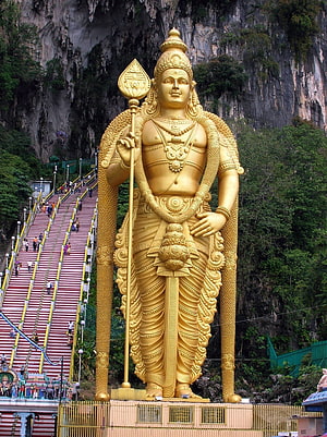 Lord Murugan Golden Statue at Batu Caves with Iconic Staircase and Limestone Cliffs HD phone wallpaper