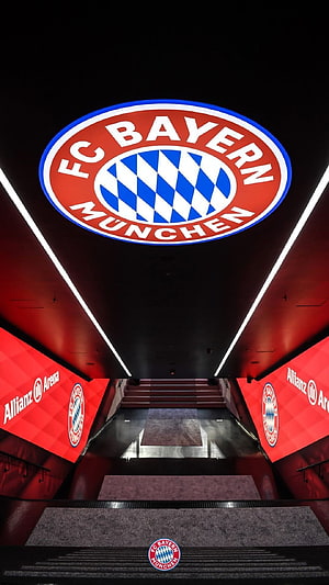 FC Bayern München Player Tunnel at Allianz Arena with Glowing Club Crest and Red LED Walls HD phone wallpaper