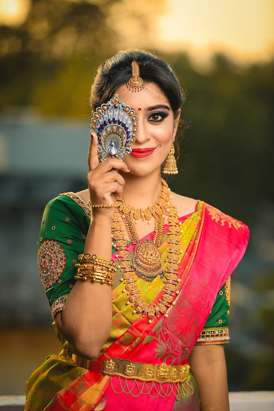 Indian Bride in Pink and Green Saree with Traditional Gold Jewelry and Peacock Mirror HD phone wallpaper