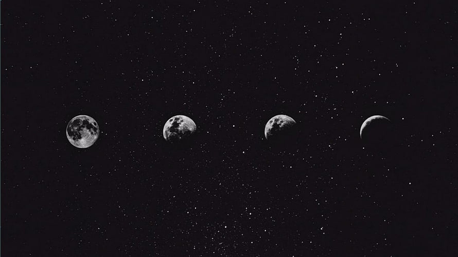 Black and White Moon Phases Sequence Against a Starry Night Sky HD wallpaper
