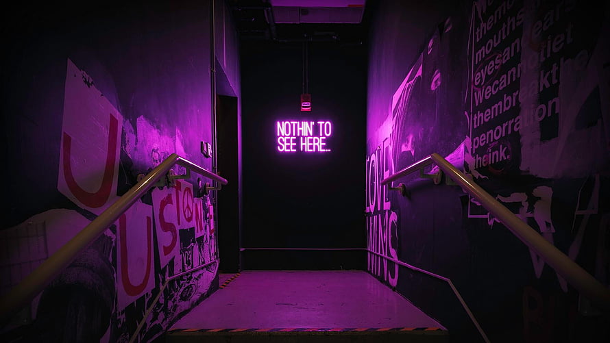 Purple Neon Sign in Dark Urban Stairwell with Graffiti Walls HD wallpaper