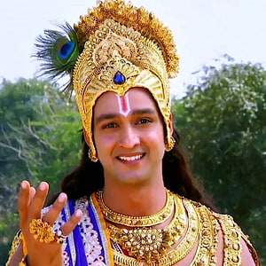 Krishna with peacock feather crown and golden jewelry smiling portrait HD phone wallpaper