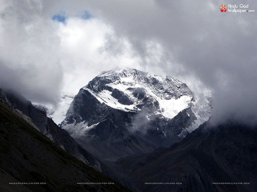 Om Parvat Snow-Capped Mountain Peak Emerging from Dramatic Clouds HD wallpaper