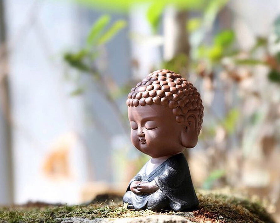 Cute Chibi Buddha Statue Meditating on Moss in a Serene Garden Setting HD wallpaper