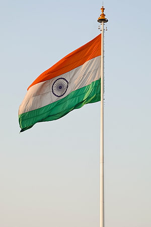 Indian National Flag Flying High on a Tall Pole Against a Clear Sky HD phone wallpaper